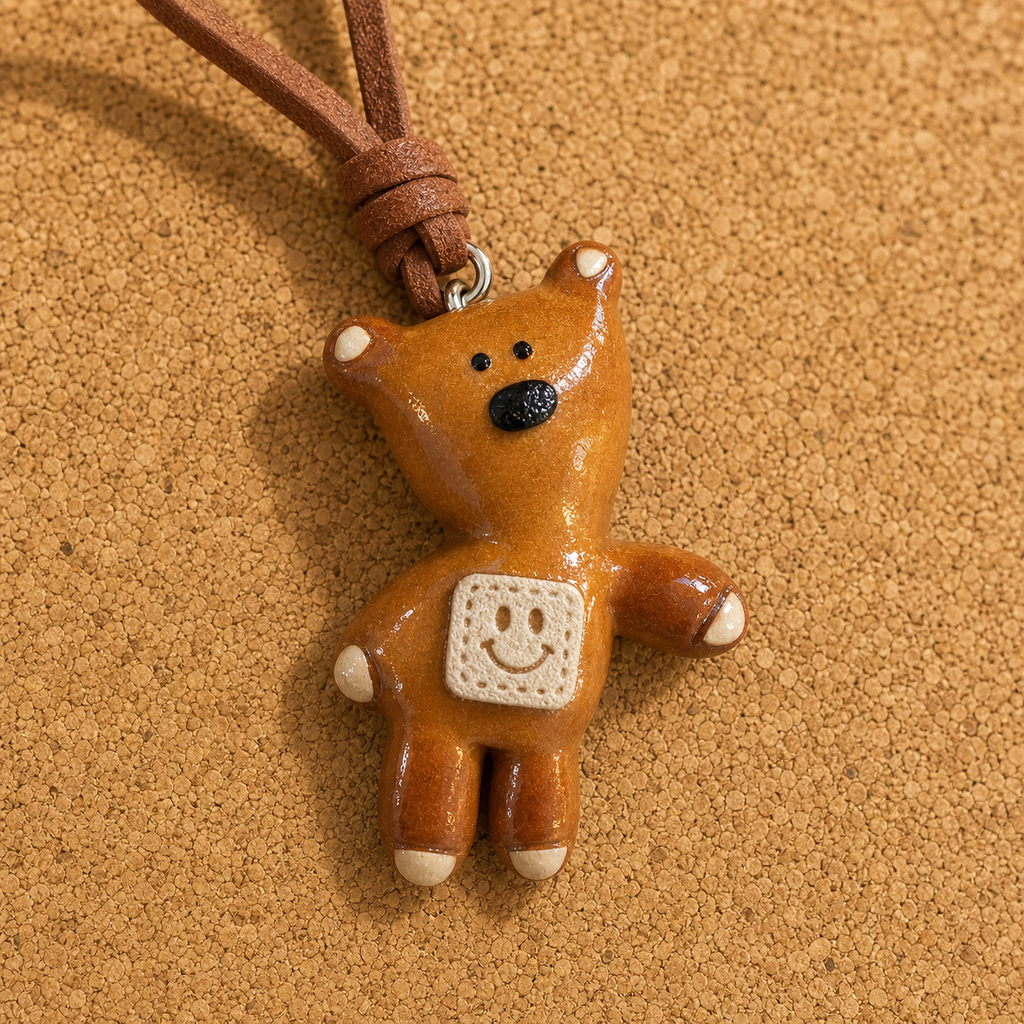 Macro view of handmade bear bread charm and textured smile patch