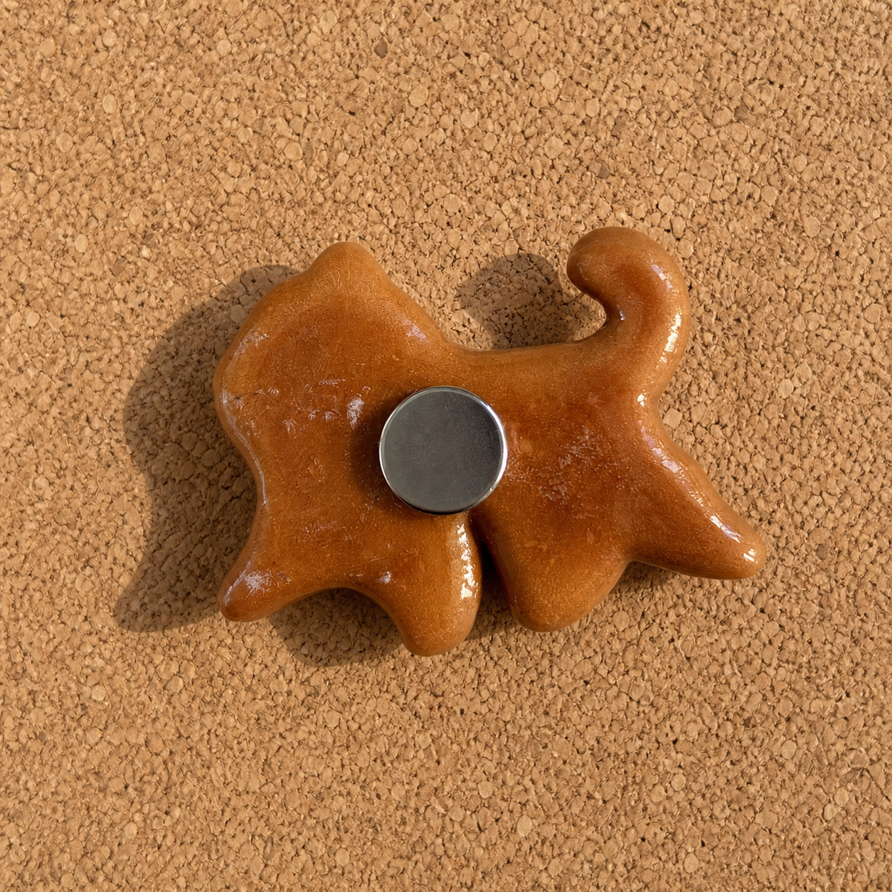 Back detail of handmade walking cat bread magnet with one round silver magnet