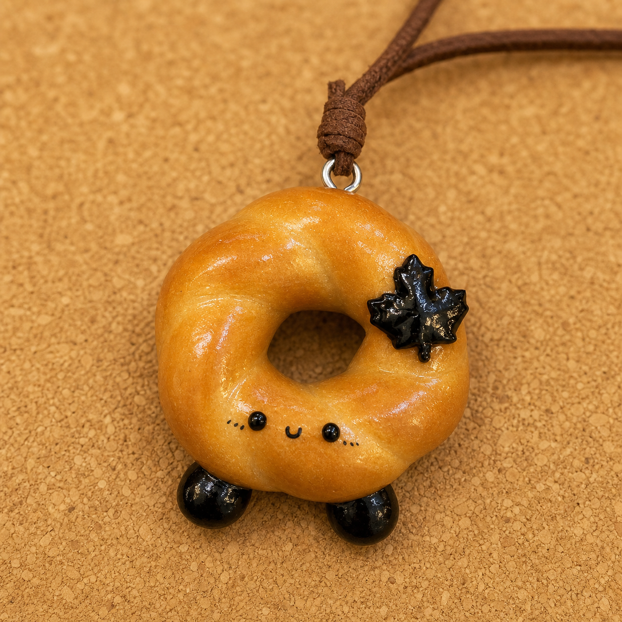 Macro detail of Doubie handmade bread art and brown leather cord
